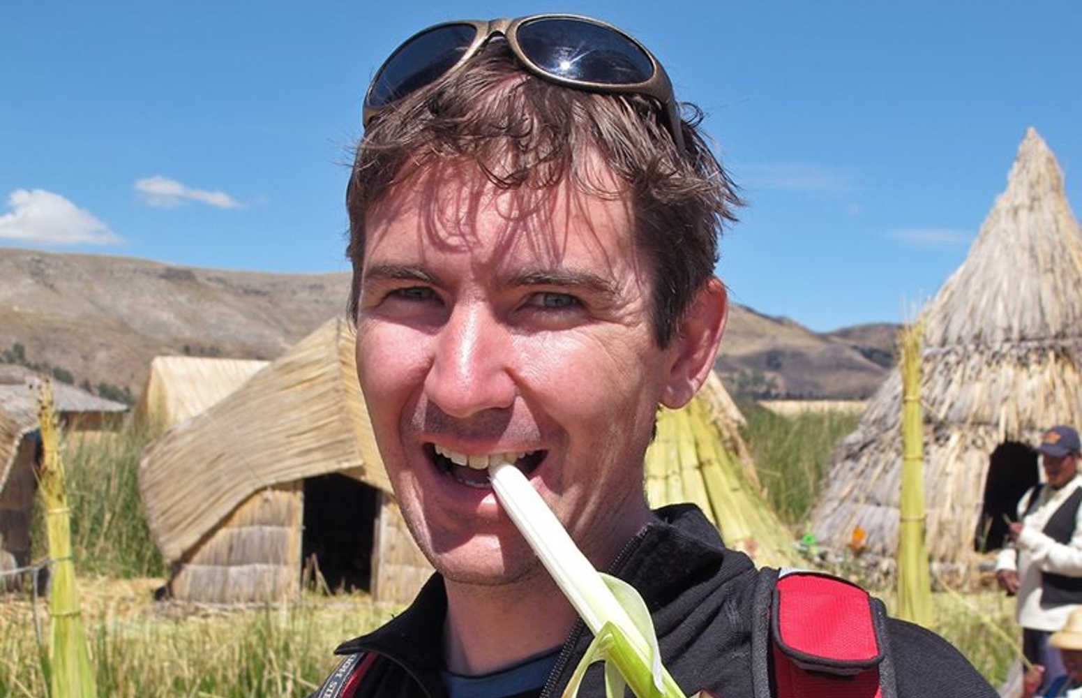 Dr Russell Barrett eating a sedge (Totora) on the Uros Islands (made of the floating Totora), Lake Titicaca, Peru.