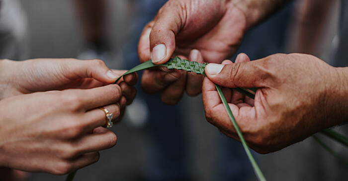 An Aboriginal Education Officer showing how to weave the Lomandra plant