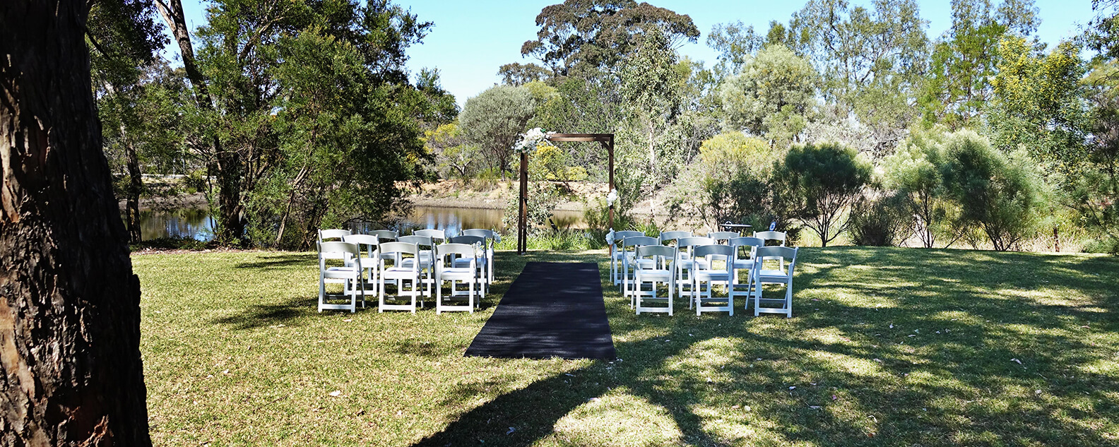 Rows of white chairs set up for an outdoor wedding