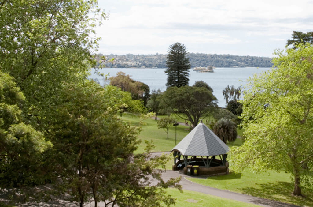 Aerial view  of picnic shelter among trees and with Sydney Harbour in background