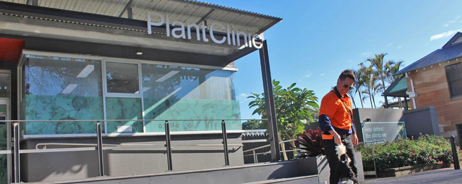 A dog trainer and their dog stand outside PlantClinic