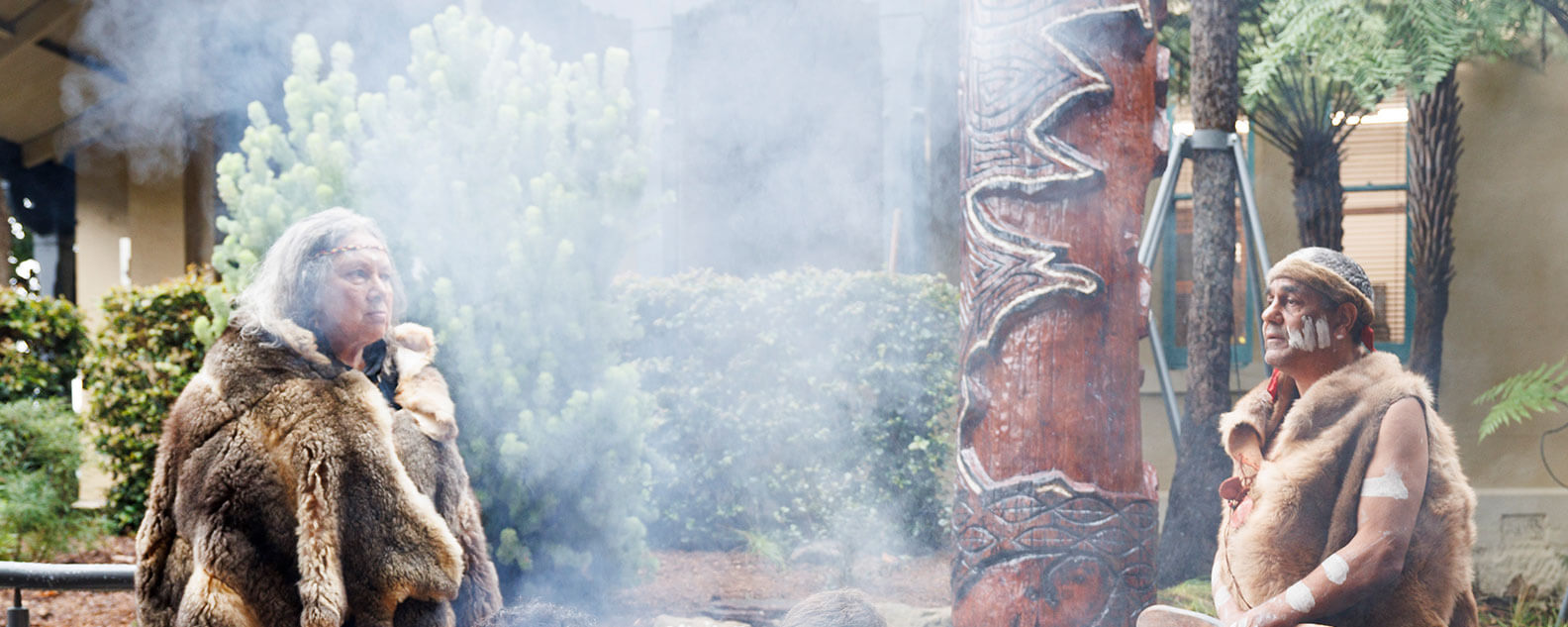 Aunty Rhonda Dixon-Grosvenor and Uncle Dean Kelly smoking and welcoming  Yer’ung – Spirit Tree to its home at the Royal Botanic Garden Sydney