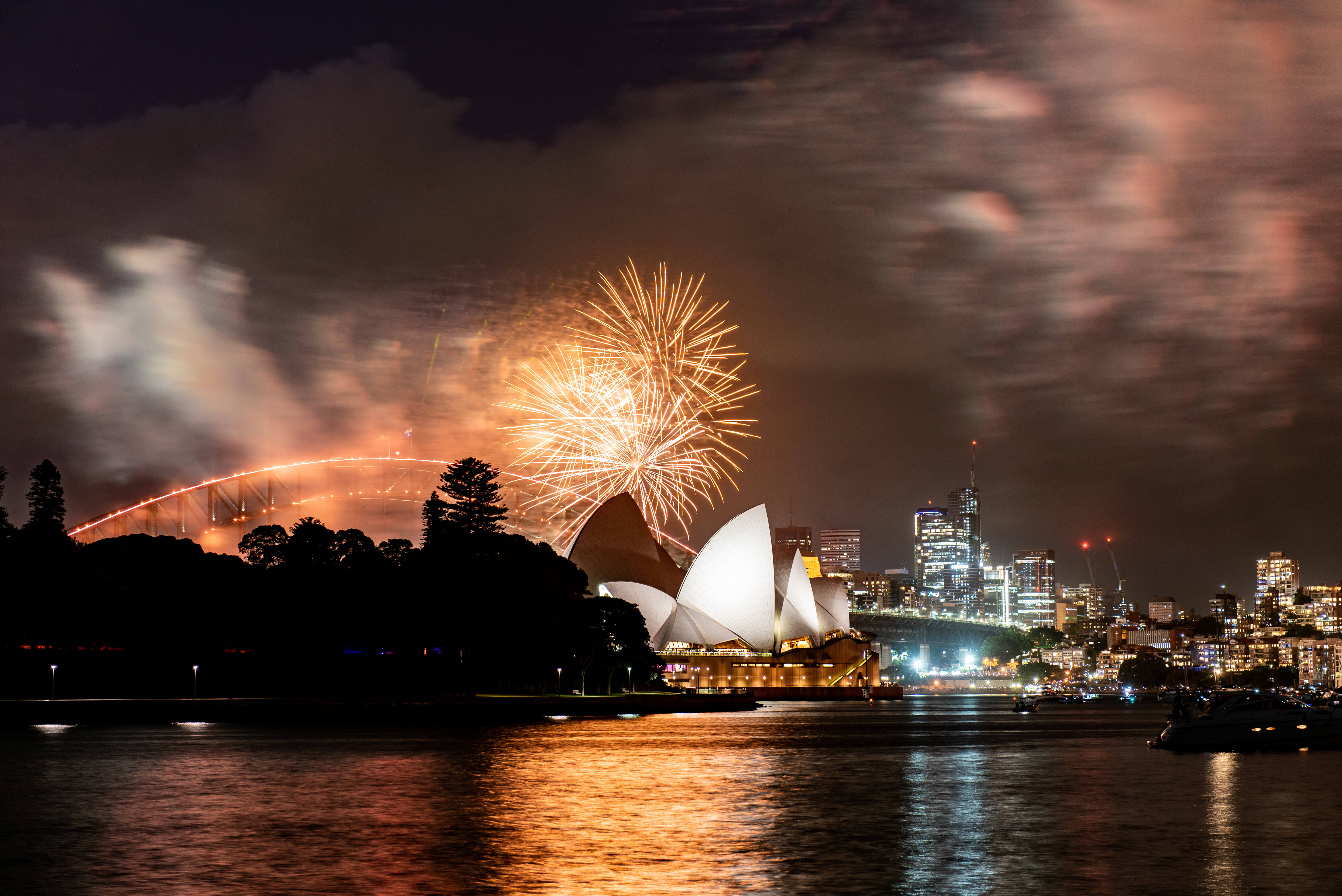 The fireworks in the background with the Opera House and Harbour Bridge