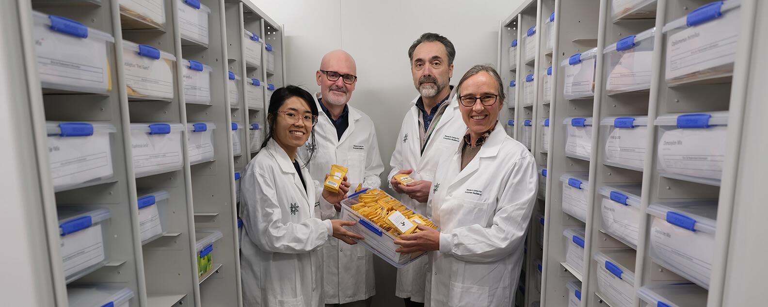 A team of scientists stand in a lab