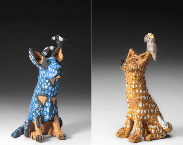 2 ceramic dog sculptures, one is blue and one is orange