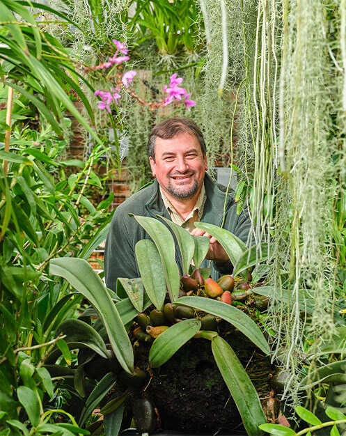 Staff member Valeriu with orchids