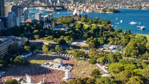 Aerial view of Field Day event at the Domain with the harbour and Sydney Harbour Bridge in the background