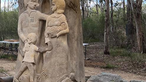 Stone sculpture of a mother, father and child