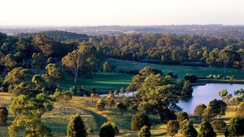 View of rolling hills, lake and distant mountains from top of sundial hill