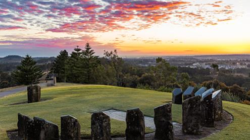 Sundial sculpture on top of hill at sunrise