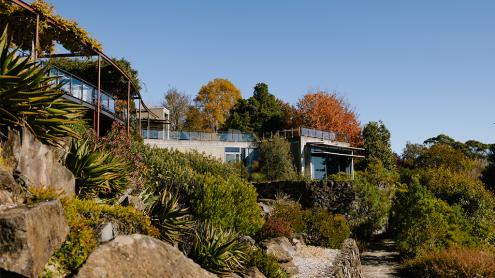 Visitor centre on a hill with garden paths below it