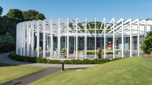 Architectural round building nestled in gardens