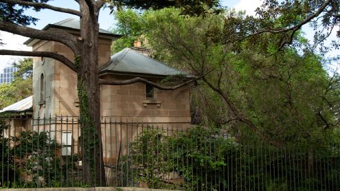 Sandstone cottage in shaded, leafy garden