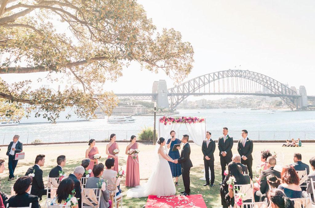 Harbour wedding on the Tarpeian Lawn at Royal Botanic Garden Sydney with Harbour Bridge in the background.