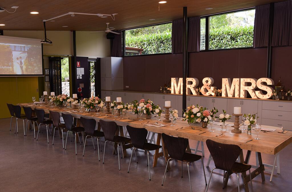 Long table set up for a wedding reception in an elegant, modern room.