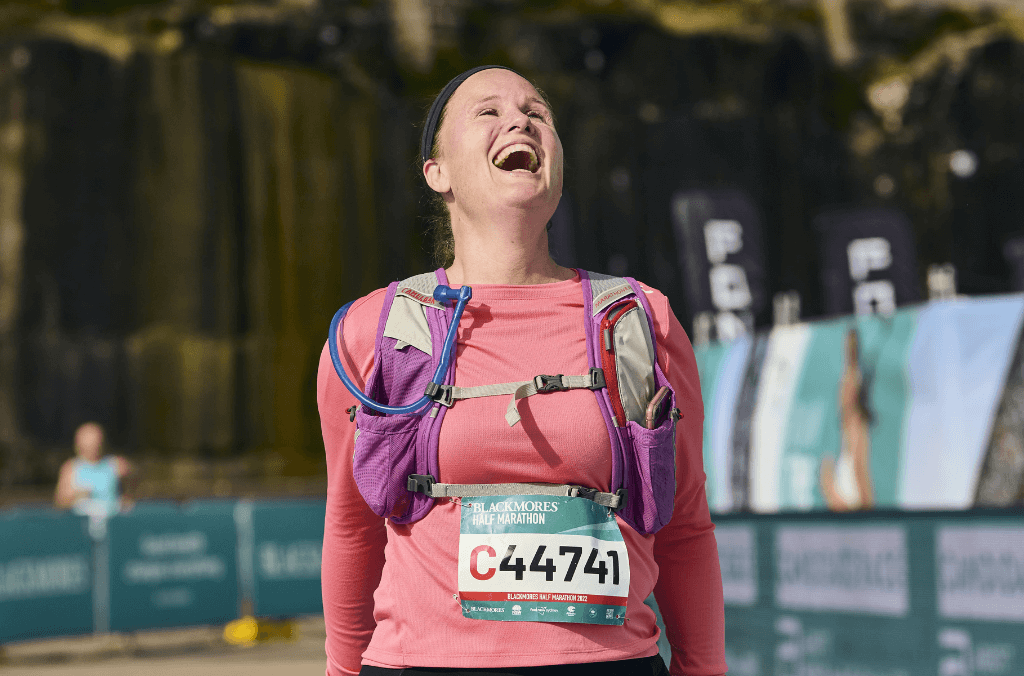 Marathon runner with number pin, laughing